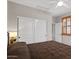 Bedroom with a ceiling fan, carpet floors, and a closet with sliding doors at 4517 E Sourwood Dr, Gilbert, AZ 85298