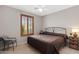 This bedroom offers carpet flooring, natural light, a ceiling fan, and a cozy ambiance at 4517 E Sourwood Dr, Gilbert, AZ 85298