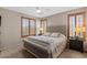 Inviting bedroom features shutters, a soft carpet, and a beautiful upholstered headboard on the bed at 4517 E Sourwood Dr, Gilbert, AZ 85298