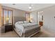 Comfortable bedroom featuring a ceiling fan, cozy carpet, and a bathroom for added convenience at 4517 E Sourwood Dr, Gilbert, AZ 85298
