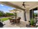 Inviting covered patio with patio furniture, grill, and views of the landscaped backyard at 4517 E Sourwood Dr, Gilbert, AZ 85298