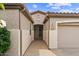 Inviting front entrance with covered walkway, decorative door, and attached garage at 4517 E Sourwood Dr, Gilbert, AZ 85298