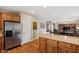 Open kitchen featuring stainless steel appliances and granite countertops with hardwood flooring throughout at 4517 E Sourwood Dr, Gilbert, AZ 85298