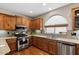 Well-equipped kitchen with stainless steel appliances, wood cabinets, and plenty of counter space at 4517 E Sourwood Dr, Gilbert, AZ 85298