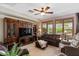 Living room featuring a built-in entertainment center, comfortable seating, and natural light through wooden shuttered windows at 4517 E Sourwood Dr, Gilbert, AZ 85298