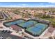 Aerial view of the community's tennis courts, adjacent neighborhood, and parking at 4517 E Sourwood Dr, Gilbert, AZ 85298