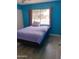 A modern bedroom design with bright paint and natural light at 4549 W Seldon Ln, Glendale, AZ 85302