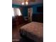 A brightly painted bedroom with natural light, closet, and dresser at 4549 W Seldon Ln, Glendale, AZ 85302