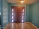 Inviting entryway showcasing a stylish front door with decorative glass panels and neutral-toned tile flooring at 4549 W Seldon Ln, Glendale, AZ 85302