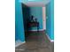 Hallway featuring bright blue walls, tile flooring, and a dark wood accent table at 4549 W Seldon Ln, Glendale, AZ 85302