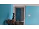 Hallway with blue walls, tile floors, and access to other rooms, with white trim at 4549 W Seldon Ln, Glendale, AZ 85302