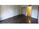 Light-filled bedroom featuring wood floors, white brick accent wall, and closet at 4800 N 68Th St # 314, Scottsdale, AZ 85251