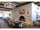 A formal dining area with a large fireplace, elegant chandelier, and set tables for guests at 4800 N 68Th St # 314, Scottsdale, AZ 85251