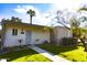 Inviting front entrance with a secure screen door, desert landscaping, and a lush green lawn at 4800 N 68Th St # 314, Scottsdale, AZ 85251