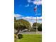 Well-maintained grounds with green lawns, mature trees, and an American flag waving in the breeze at 4800 N 68Th St # 314, Scottsdale, AZ 85251