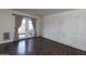 Bright living room with wood floors, white brick accent wall, and glass patio doors at 4800 N 68Th St # 314, Scottsdale, AZ 85251