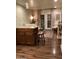 Living room with hardwood floors, French doors, and brick accent wall at 4800 N 68Th St # 314, Scottsdale, AZ 85251