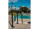 Stair access to a community pool with lounge chairs and tall palm trees under blue skies at 4800 N 68Th St # 314, Scottsdale, AZ 85251
