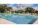 Large community pool with palm trees, lounge chairs, and beautiful blue water at 4800 N 68Th St # 314, Scottsdale, AZ 85251