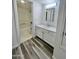 Bright bathroom features white cabinets, modern fixtures, and wood-look tile flooring at 533 W Guadalupe Rd # 1110, Mesa, AZ 85210