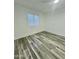 Cozy bedroom with wood-style flooring and bright natural lighting at 533 W Guadalupe Rd # 1110, Mesa, AZ 85210