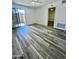 Bright living room featuring sleek gray wood flooring and sliding glass door to the balcony at 533 W Guadalupe Rd # 1110, Mesa, AZ 85210