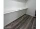 Bright storage space with wood-style flooring and shelf at 533 W Guadalupe Rd # 1110, Mesa, AZ 85210
