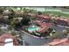 Aerial view of a community with a sparkling pool, lush green spaces, and well-maintained landscaping at 5450 E Mclellan Rd # 145, Mesa, AZ 85205
