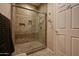 Walk-in shower featuring custom tile work, glass door, and built-in shelving at 5450 E Mclellan Rd # 145, Mesa, AZ 85205