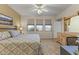 Cozy bedroom featuring a ceiling fan, dresser, and a view from the windows at 5450 E Mclellan Rd # 145, Mesa, AZ 85205