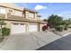 Condo building featuring attached garages, desert landscaping, and red tile roofing at 5450 E Mclellan Rd # 145, Mesa, AZ 85205