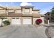 Condo building featuring attached garages, desert landscaping, and red tile roofing at 5450 E Mclellan Rd # 145, Mesa, AZ 85205