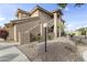 Tan stucco condo building featuring a private stairwell entry and desert landscaping at 5450 E Mclellan Rd # 145, Mesa, AZ 85205