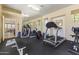 Bright gym with various fitness machines, a mirrored wall, and a view of the community at 5450 E Mclellan Rd # 145, Mesa, AZ 85205