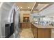 Spacious kitchen featuring stainless steel refrigerator, granite countertops, and tiled floors at 5450 E Mclellan Rd # 145, Mesa, AZ 85205