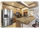 Well-lit kitchen with stainless steel appliances, granite counters, and bar stool seating at 5450 E Mclellan Rd # 145, Mesa, AZ 85205