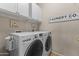Bright laundry room with storage cabinets and modern washer/dryer at 5450 E Mclellan Rd # 145, Mesa, AZ 85205