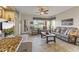 Bright and spacious living room featuring tile floors and a large window with golf course views at 5450 E Mclellan Rd # 145, Mesa, AZ 85205