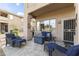 Covered patio with outdoor seating, fire pit and neutral stone pavers at 5450 E Mclellan Rd # 145, Mesa, AZ 85205