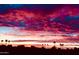 Breathtaking view of vivid red and pink sunset over desert landscape with silhouetted palms at 5450 E Mclellan Rd # 145, Mesa, AZ 85205