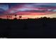 Dramatic sunset paints the sky with vibrant hues, creating a serene backdrop for the community at 5450 E Mclellan Rd # 145, Mesa, AZ 85205