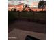 Relaxing backyard view featuring patio seating, an iron fence overlooking a sunset, and the community golf course at 5450 E Mclellan Rd # 150, Mesa, AZ 85205