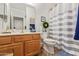 Bathroom featuring blue and white striped shower curtain and wood cabinets at 5450 E Mclellan Rd # 150, Mesa, AZ 85205