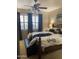 Bedroom featuring plantation shutters, and a bed with a navy throw blanket at 5450 E Mclellan Rd # 150, Mesa, AZ 85205