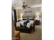 Cozy bedroom with a ceiling fan, floral bedding, and carpet at 5450 E Mclellan Rd # 150, Mesa, AZ 85205