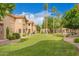 Beautiful grassy community area with mature trees and desert landscaping under sunny blue skies at 5450 E Mclellan Rd # 150, Mesa, AZ 85205