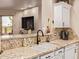 Granite counters highlight this kitchen, showcasing a stainless steel sink and white cabinetry at 5450 E Mclellan Rd # 150, Mesa, AZ 85205