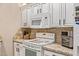 A well-lit kitchen featuring white cabinetry, granite countertops, and modern appliances at 5450 E Mclellan Rd # 150, Mesa, AZ 85205