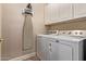 Laundry room with a washer, dryer, and ironing board at 5450 E Mclellan Rd # 150, Mesa, AZ 85205