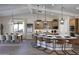 Bright, open kitchen featuring stainless steel appliances, a large island with seating, and stylish pendant lighting at 6094 N Sunrise Ln, Buckeye, AZ 85396